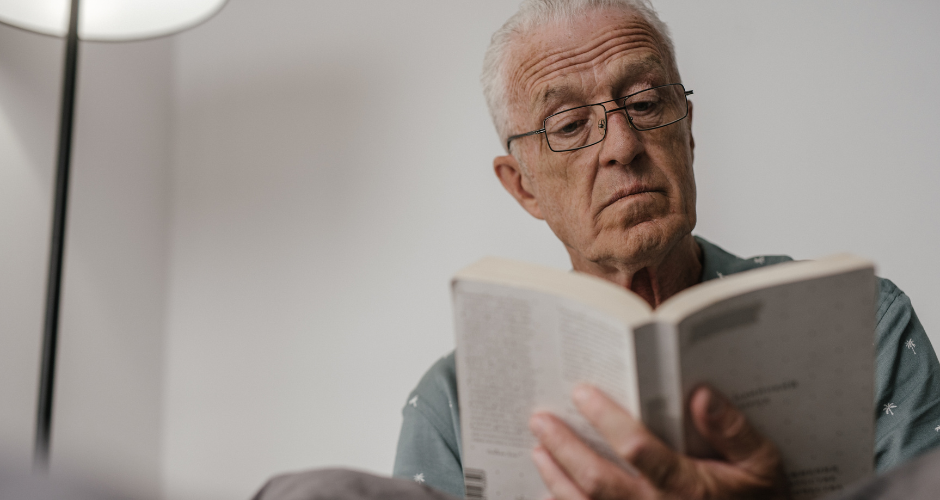 Older man reading a book